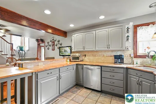 a kitchen with a sink window and cabinets