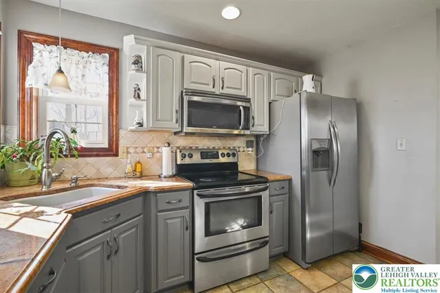 a kitchen with a stove microwave and refrigerator