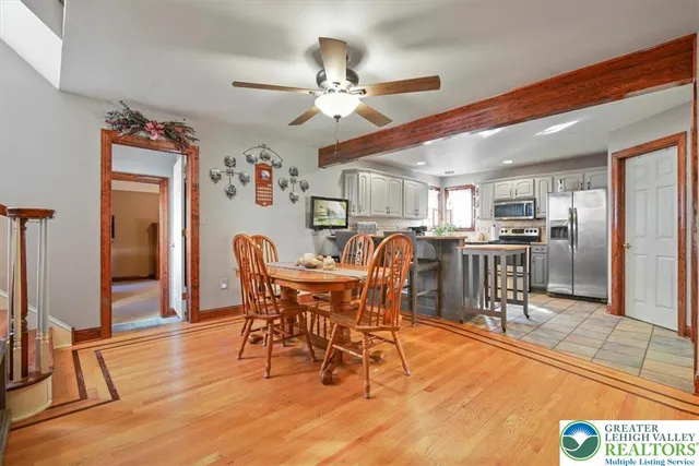 a view of a dining room with furniture and chandelier