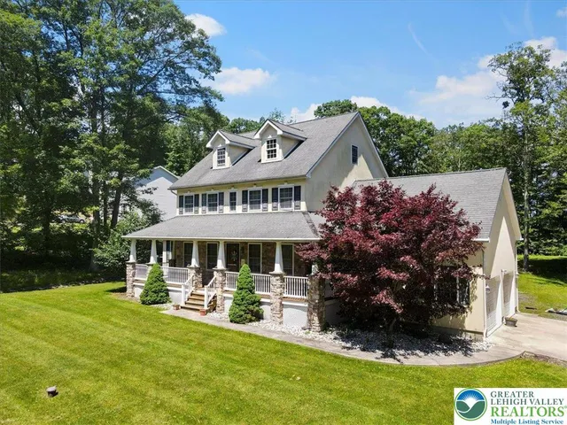 a view of a house with a yard balcony and sitting area