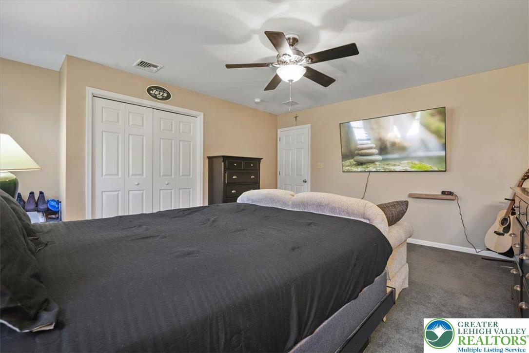 118 Hollow Drive Stroudsburg, PA 18360 - Photo 34 of 45 a spacious bedroom with a bed and a chandelier