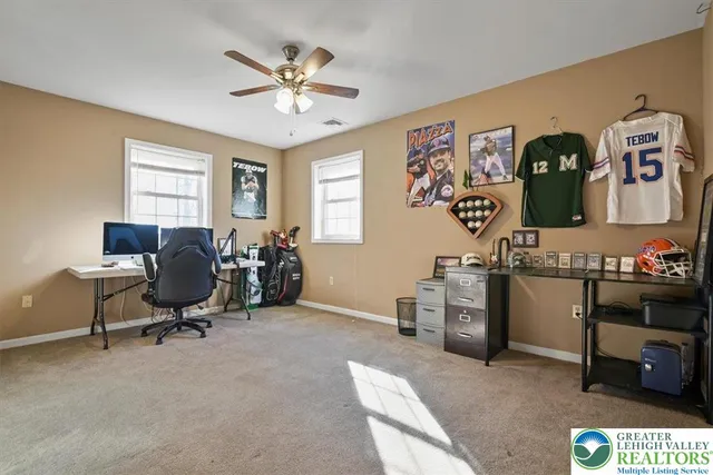 a view of a workspace with furniture and a window