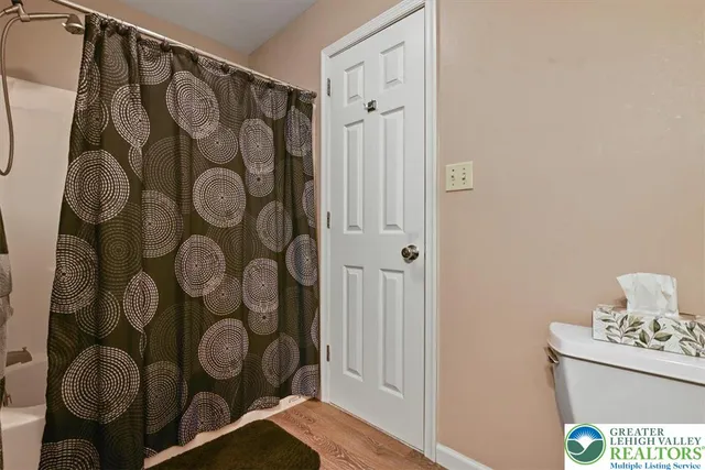a bathroom with a mirror and shower curtain