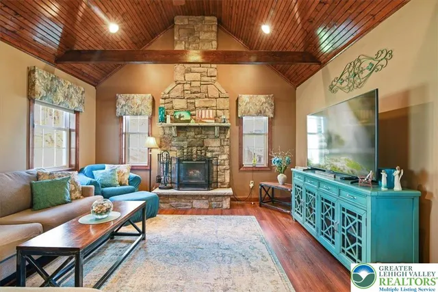 a living room with furniture and a fireplace