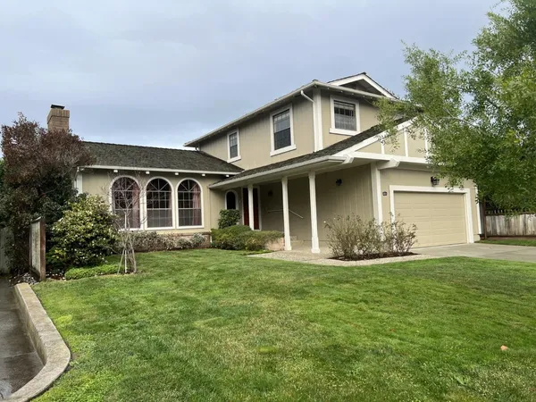 a front view of a house with a yard