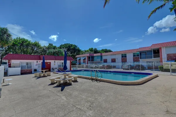 a swimming pool with outdoor seating and yard