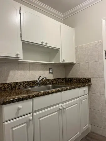 a stove top oven sitting inside of a kitchen
