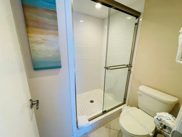 a bathroom with a shower and toilet