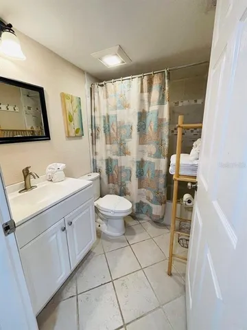 a bathroom with a sink mirror toilet and shower