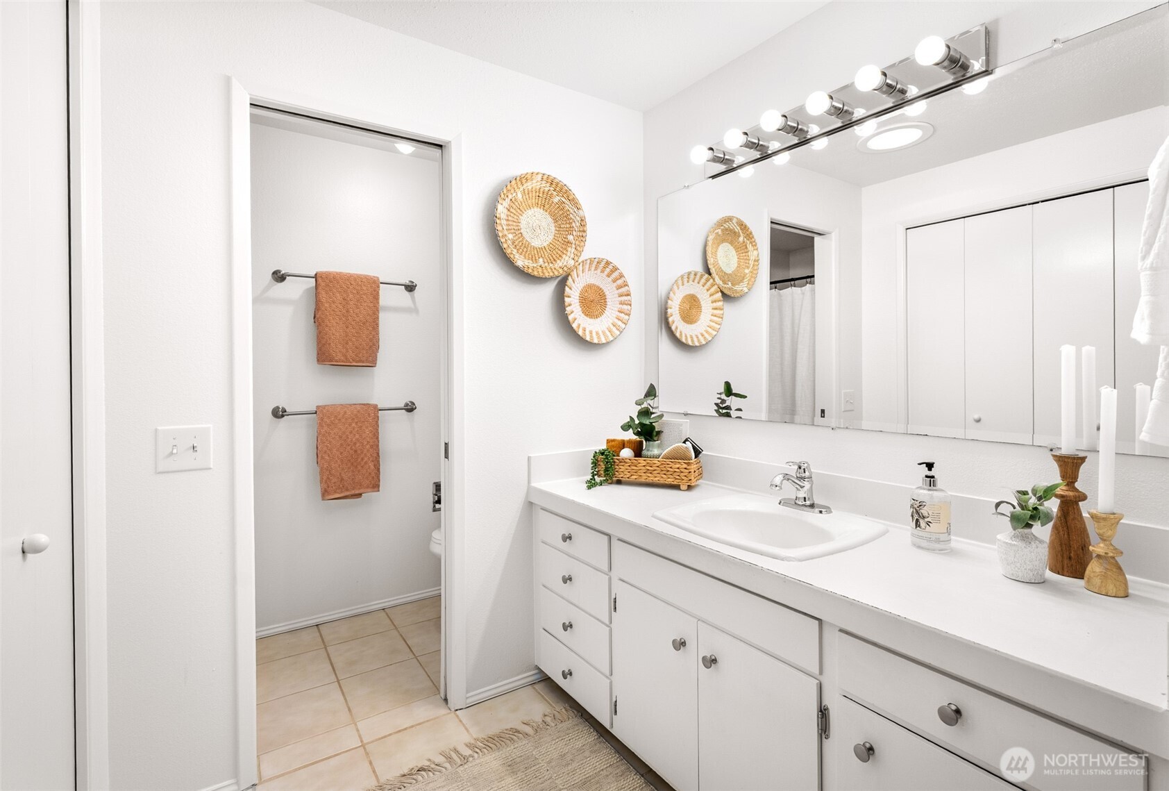 15727 Cascadian Way Bothell, WA 98012 - Photo 11 of 40 a bathroom with a sink and a clock on the wall