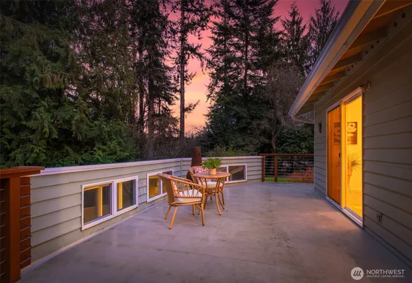 a view of a house with backyard porch and sitting area