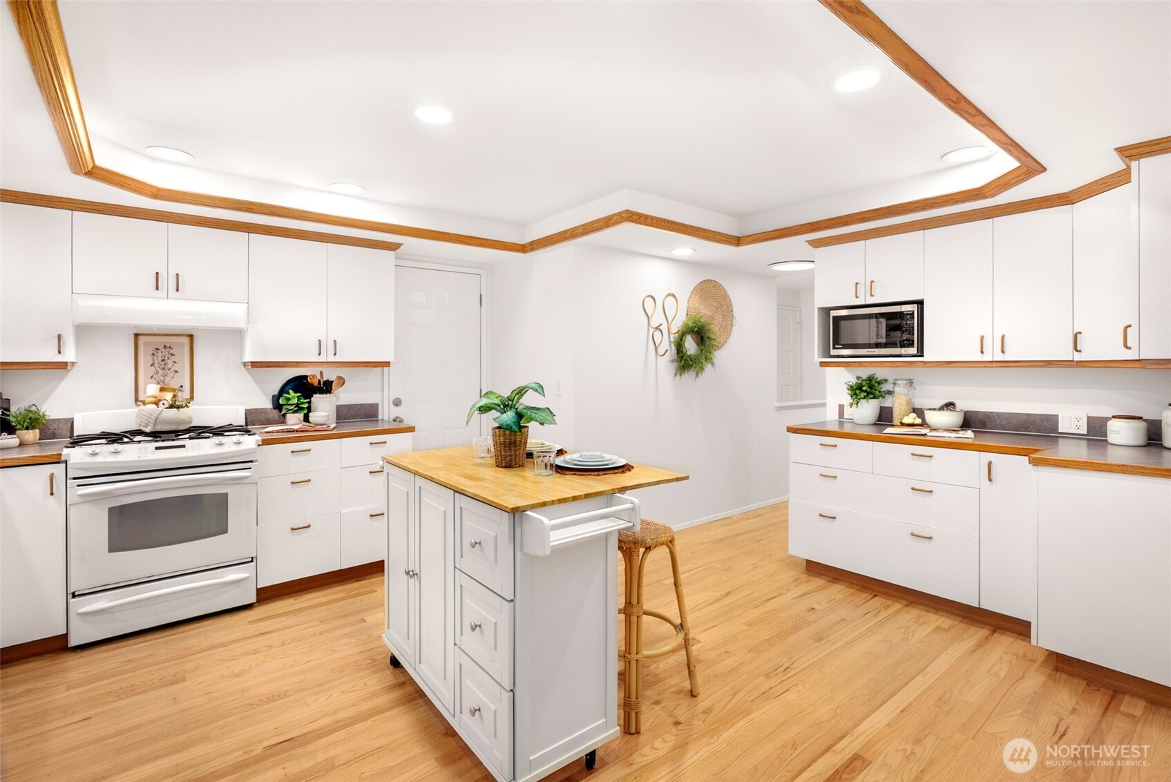 15727 Cascadian Way Bothell, WA 98012 - Photo 7 of 40 a kitchen with granite countertop white cabinets and white appliances