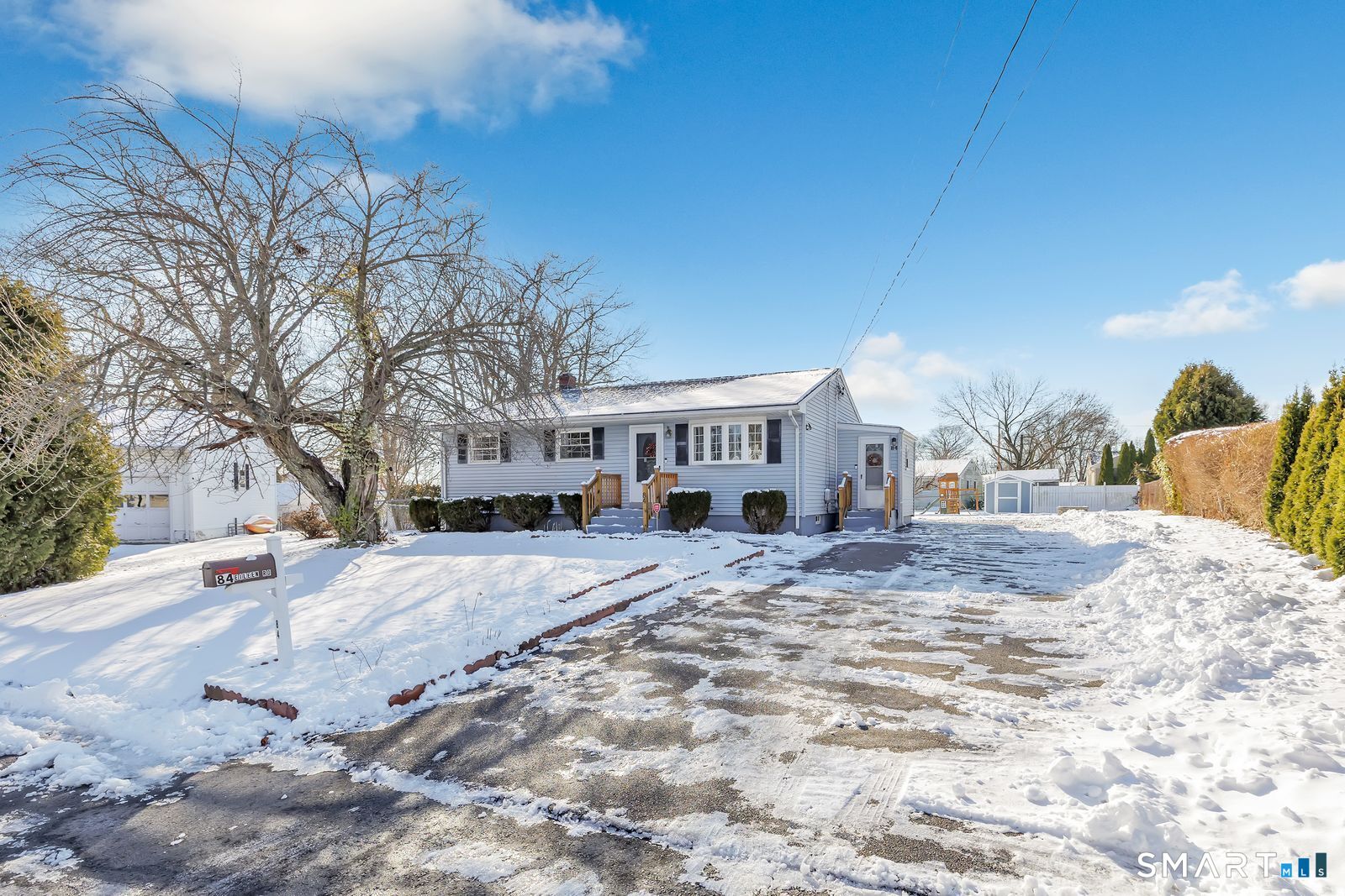 a view of a house with snow on the road