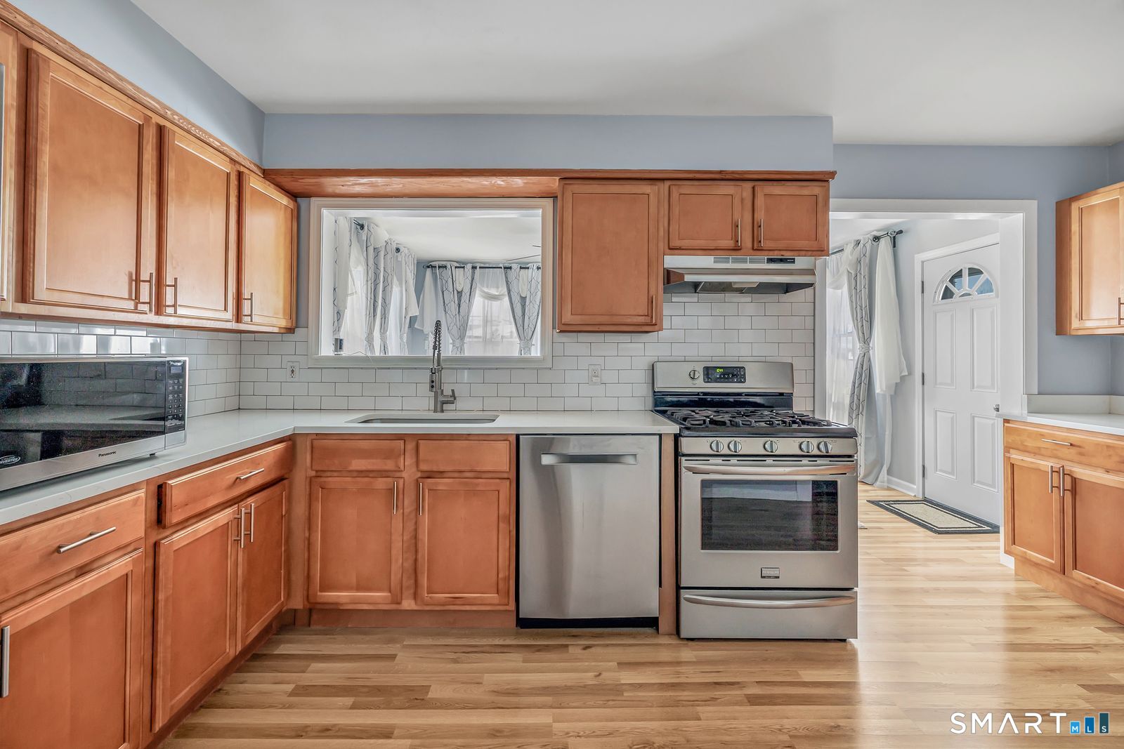 84 Eileen Road West Haven, CT 06516 - Photo 11 of 37 a kitchen with stainless steel appliances granite countertop a stove and a sink
