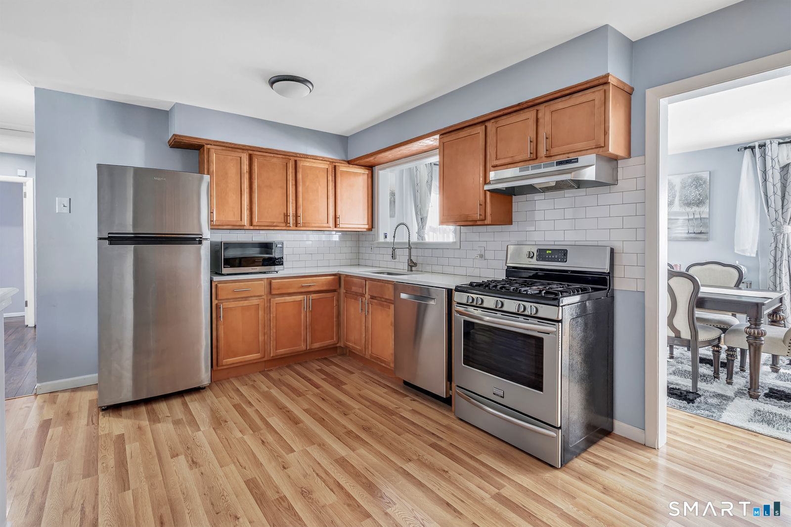 84 Eileen Road West Haven, CT 06516 - Photo 12 of 37 a kitchen with a stove a sink and a refrigerator