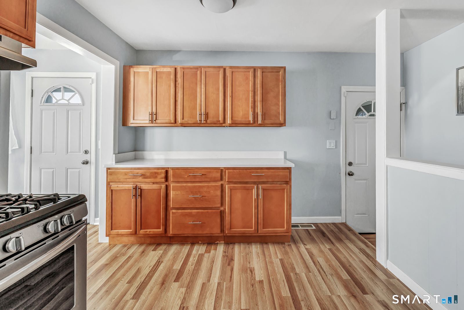 84 Eileen Road West Haven, CT 06516 - Photo 14 of 37 a kitchen with wooden floors and a stove top oven