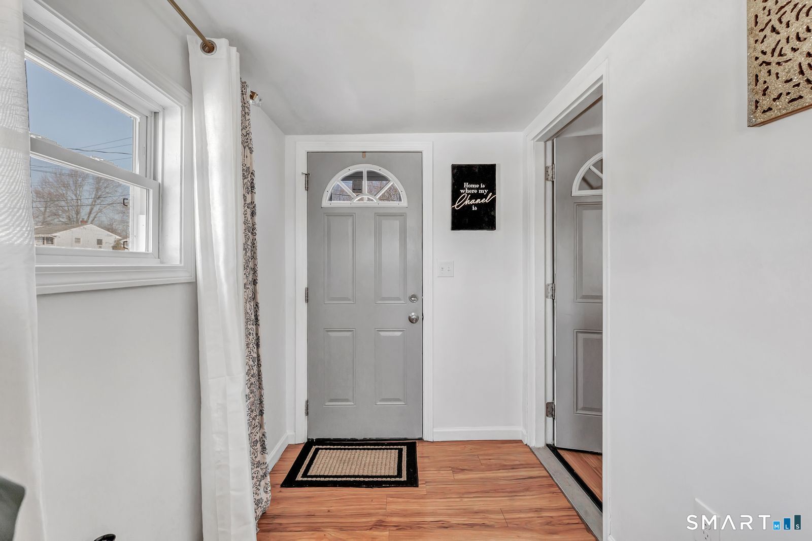 84 Eileen Road West Haven, CT 06516 - Photo 18 of 37 a view of a hallway with wooden floor and a living room