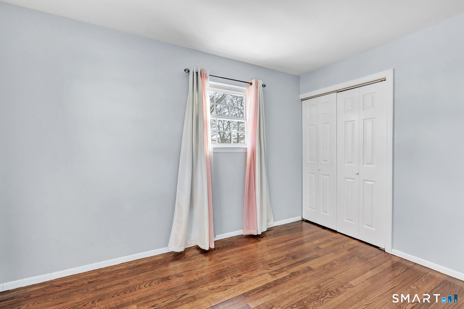 84 Eileen Road West Haven, CT 06516 - Photo 21 of 37 an empty room with wooden floor and windows