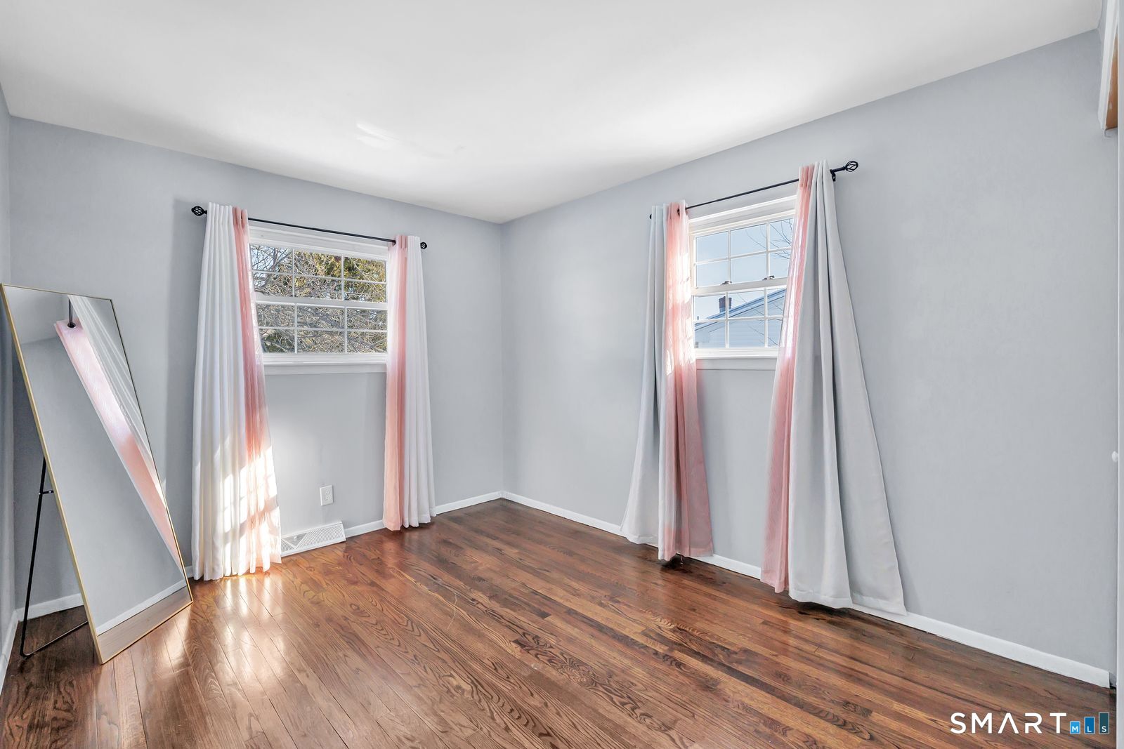 84 Eileen Road West Haven, CT 06516 - Photo 23 of 37 an empty room with wooden floor and a window