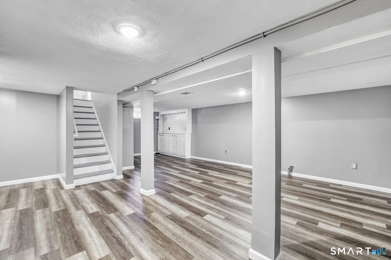 84 Eileen Road West Haven, CT 06516 - Photo 27 of 37 a view of a bedroom with a bed and stairs