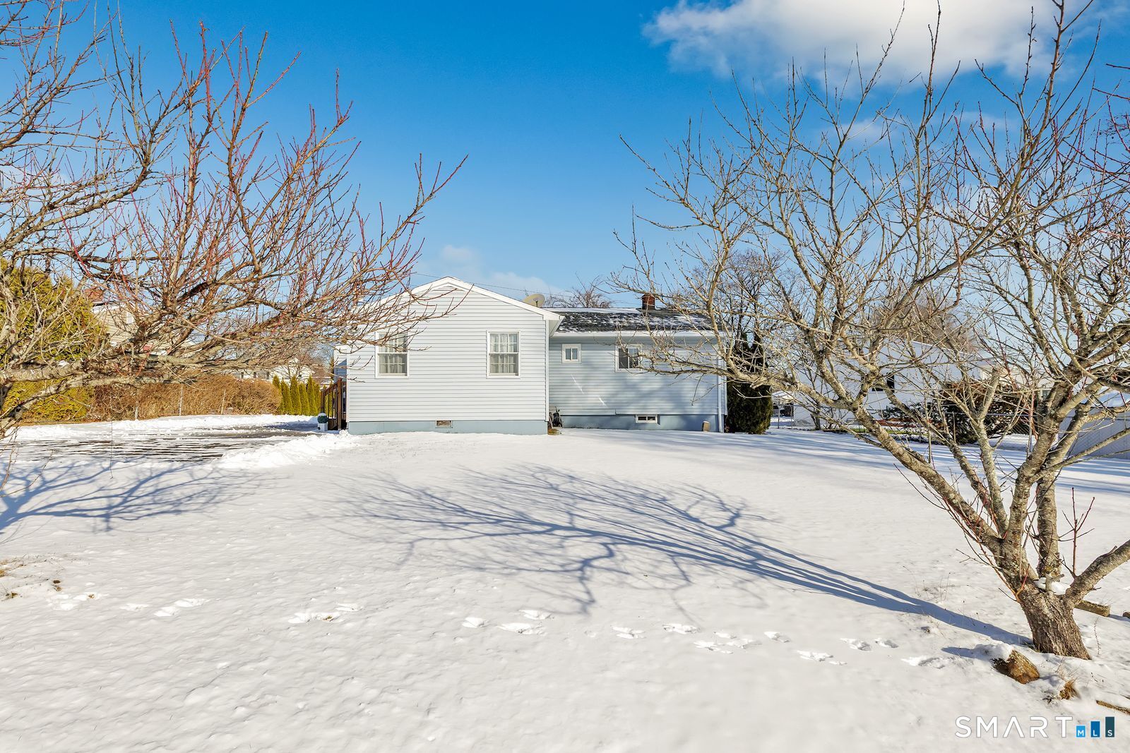 84 Eileen Road West Haven, CT 06516 - Photo 32 of 37 a view of a white house with a snow