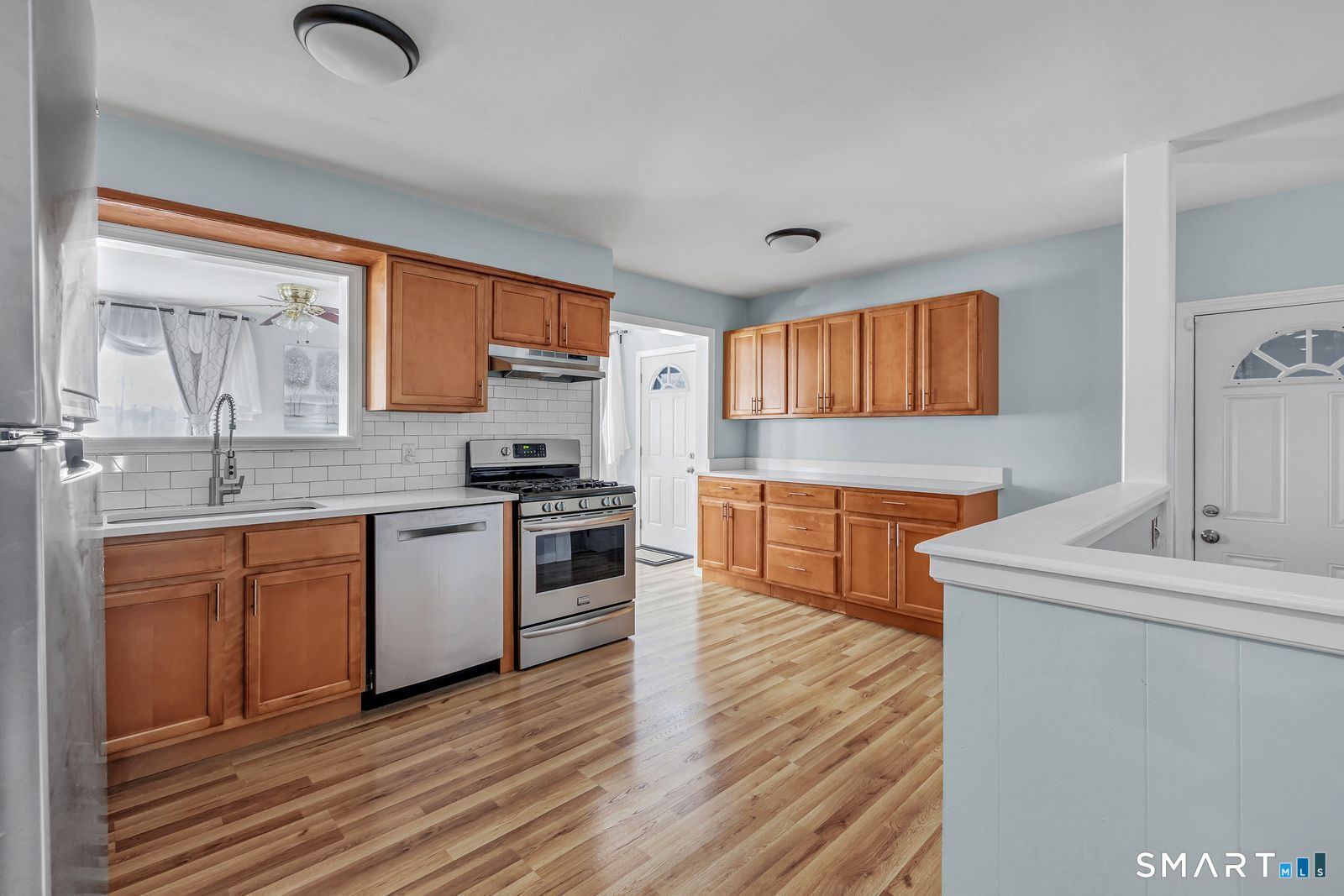84 Eileen Road West Haven, CT 06516 - Photo 10 of 37 a kitchen with stainless steel appliances kitchen island granite countertop a sink cabinets and wooden floor