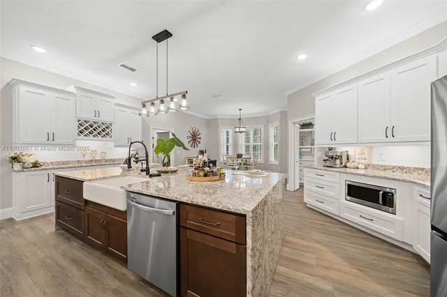 a kitchen with kitchen island white cabinets and white appliances
