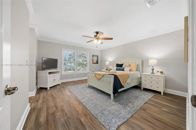 a bedroom with a bed a flat screen tv and a couch