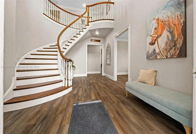 a living room with furniture and stairs