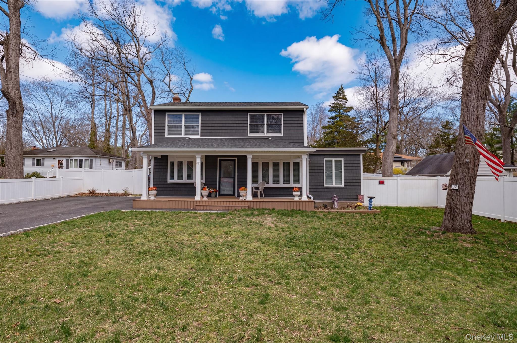 27 Half Mile Road Middle Island, NY 11953 - Photo 1 of 35 Traditional-style home with a chimney, covered porch, and asphalt driveway