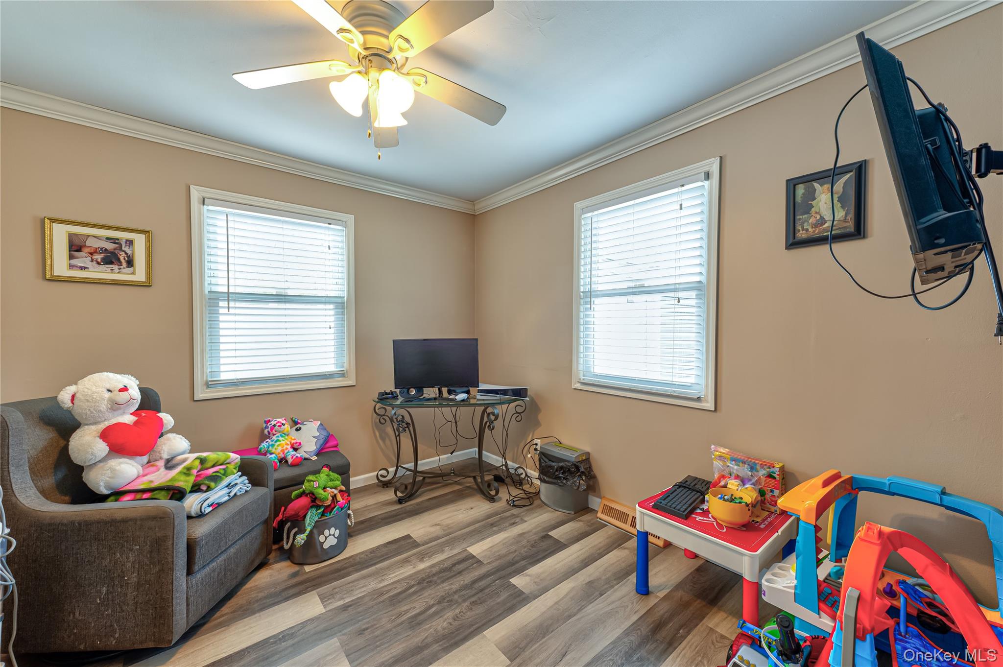 27 Half Mile Road Middle Island, NY 11953 - Photo 14 of 35 Recreation room grayish floors, ornamental molding, ceiling fan, and healthy amount of natural light