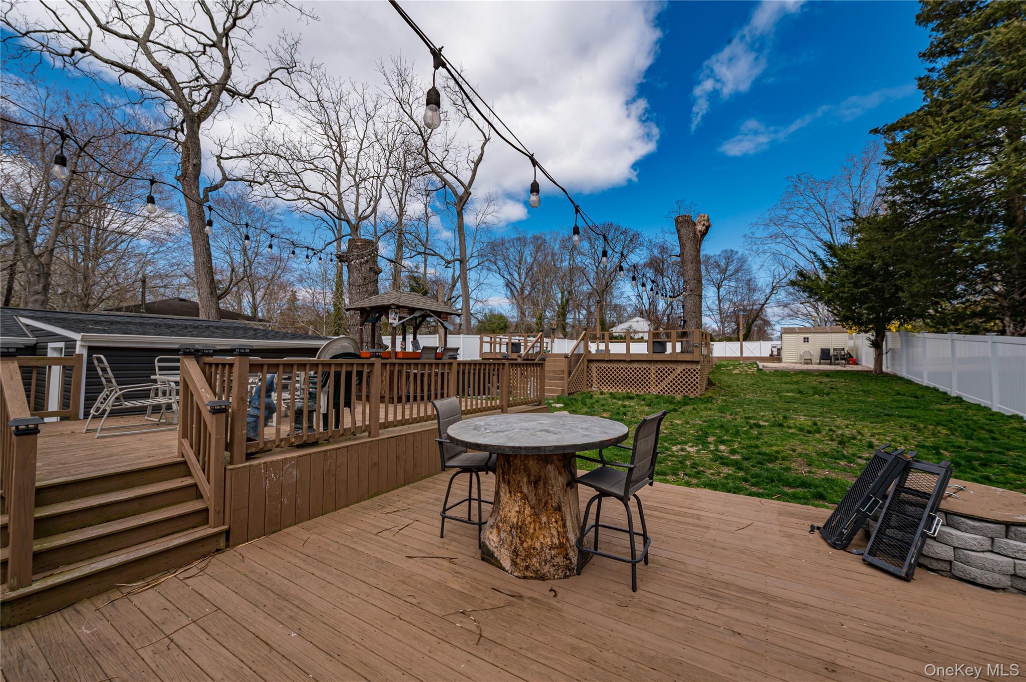 27 Half Mile Road Middle Island, NY 11953 - Photo 21 of 35 Wooden deck featuring outdoor dining space and a fenced backyard