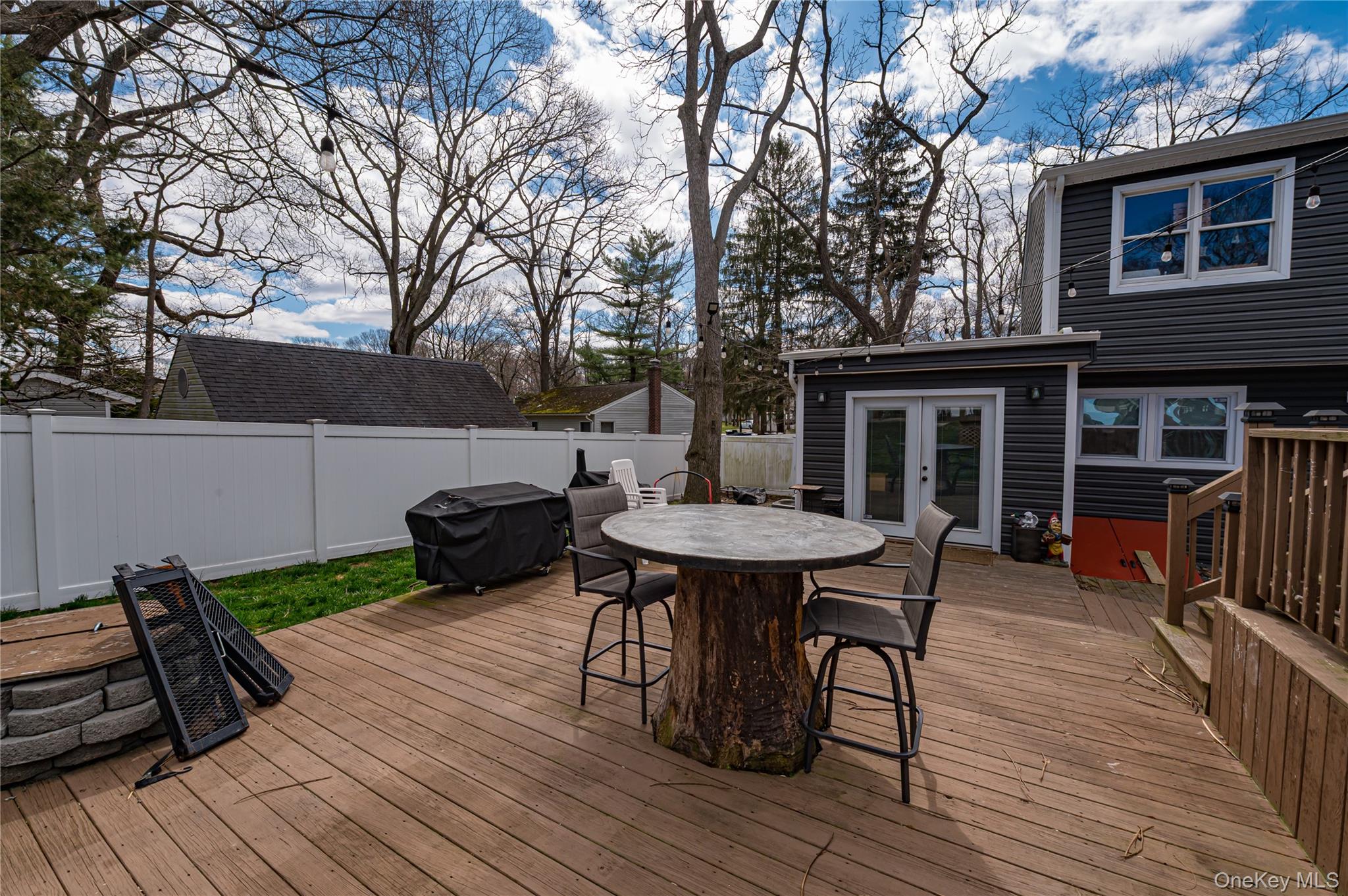 27 Half Mile Road Middle Island, NY 11953 - Photo 25 of 35 Wooden deck with rear doors, area for grilling, a fenced backyard, and outdoor dining space