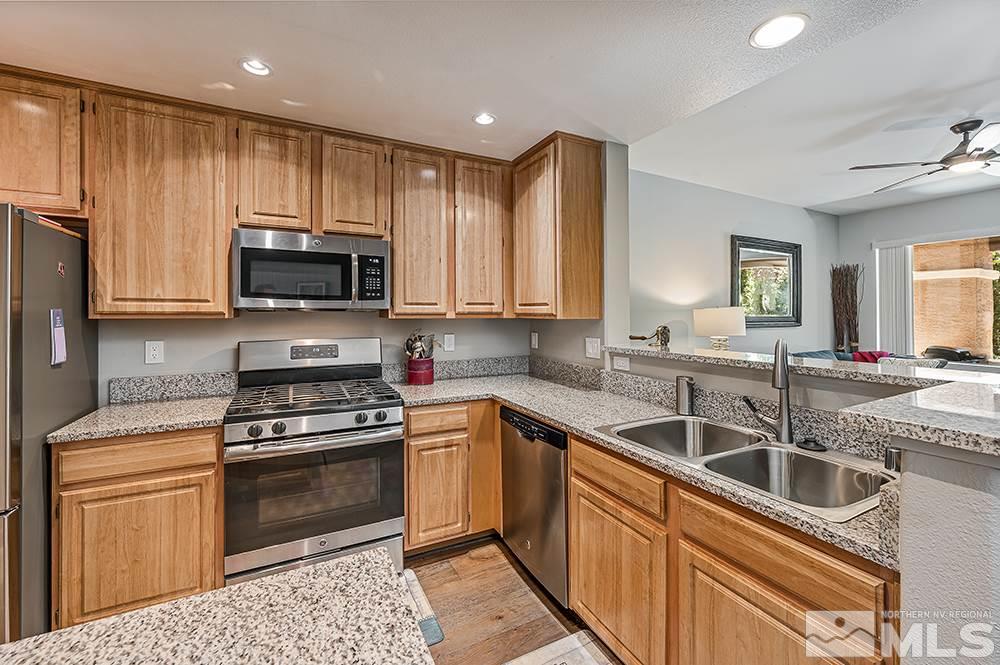 900 S, Unit 2312 Reno, NV 89521 - Photo 4 of 20 a kitchen with a sink stove top oven and refrigerator