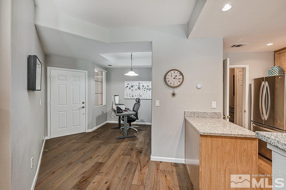 900 S, Unit 2312 Reno, NV 89521 - Photo 6 of 20 a kitchen with stainless steel appliances granite countertop a refrigerator a sink and wooden floors