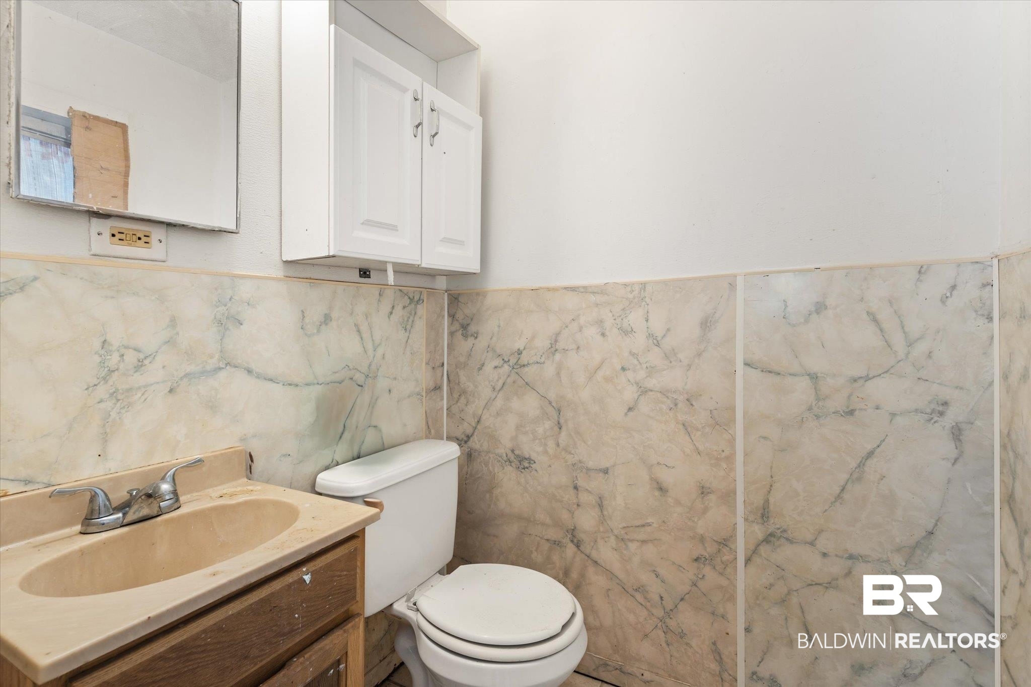 672 Burden Street Mobile, AL 36607 - Photo 12 of 20 Half bathroom featuring toilet, tile walls, vanity, and a wainscoted wall