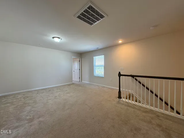 a view of an empty room and stairs