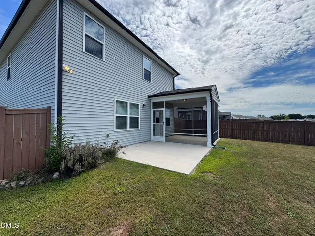 a view of a house with backyard and porch