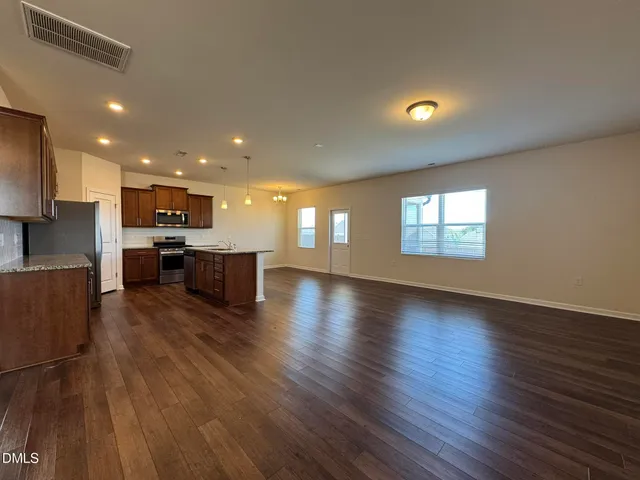 a view of kitchen with stove and wooden floor