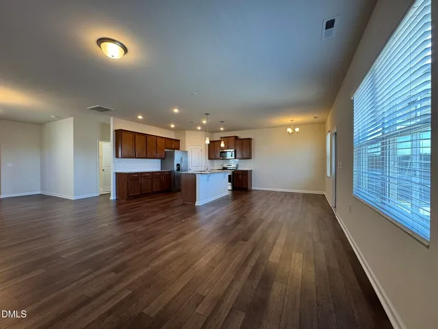a view of kitchen and hall with wooden floor
