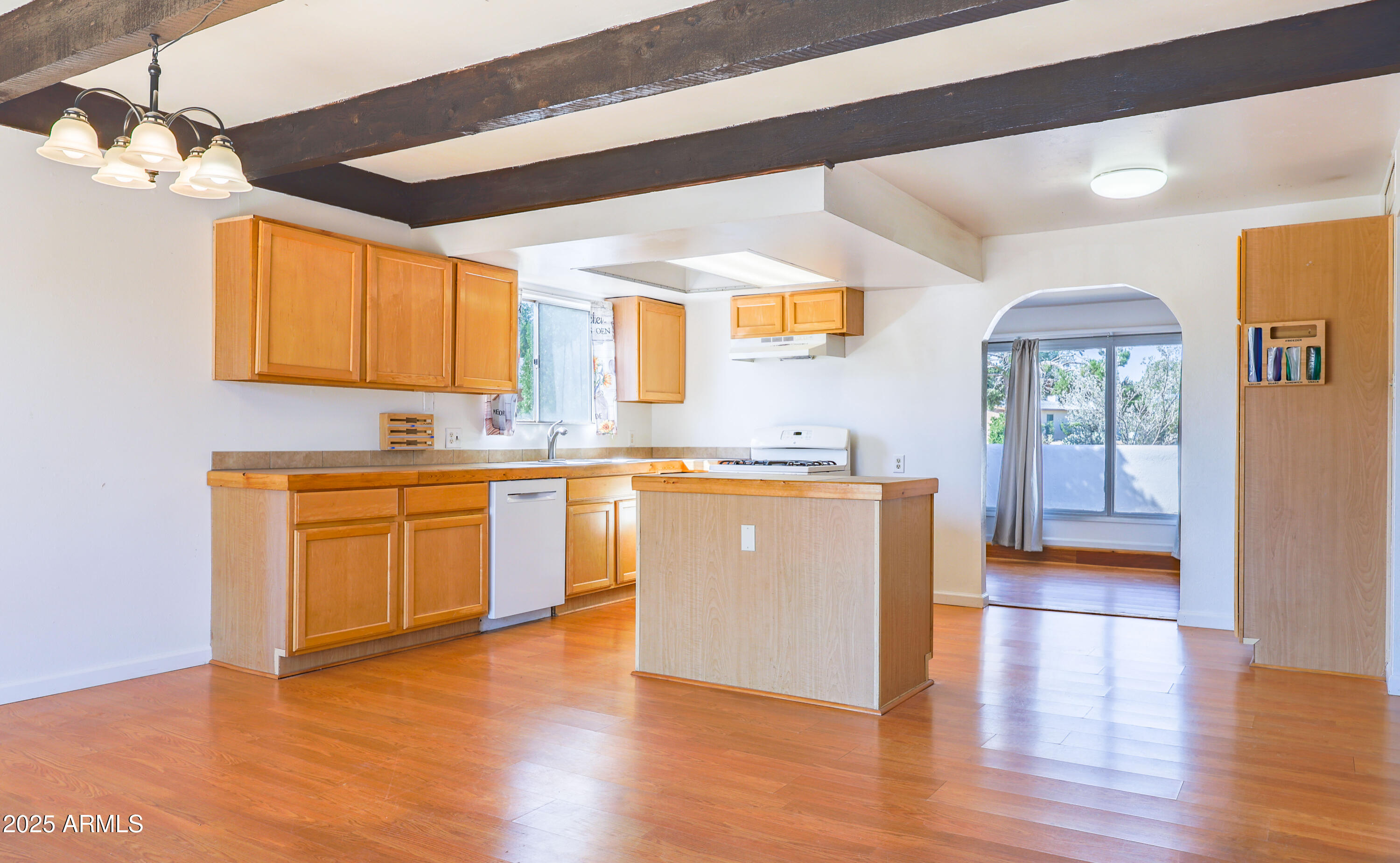106 Neff Place Pearce, AZ 85625 - Photo 11 of 28 a kitchen with wooden floors and white appliances