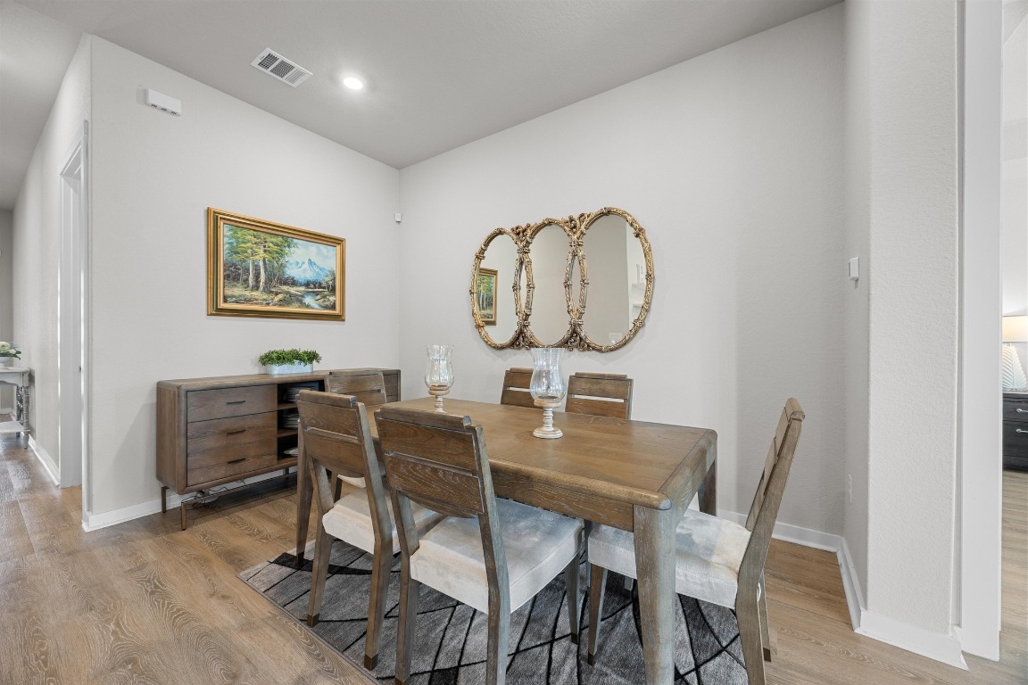 401 Peace Pipe Way Georgetown, TX 78628 - Photo 14 of 37 a view of a dining room with furniture and a mirror