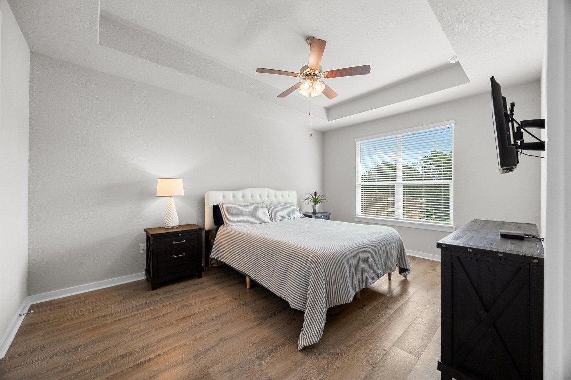 401 Peace Pipe Way Georgetown, TX 78628 - Photo 15 of 37 a bedroom with a bed and a window