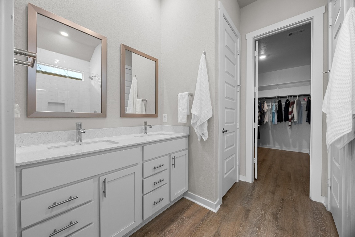 401 Peace Pipe Way Georgetown, TX 78628 - Photo 18 of 37 a bathroom with a double vanity sink and mirror