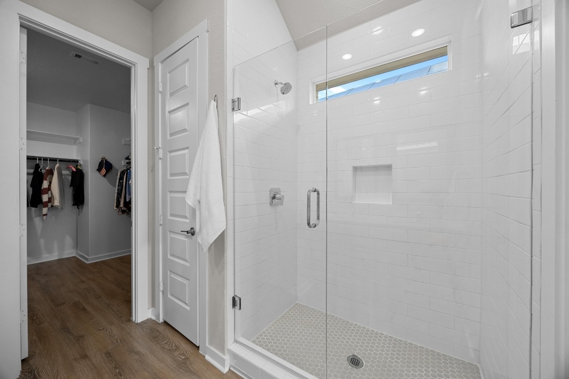 401 Peace Pipe Way Georgetown, TX 78628 - Photo 19 of 37 a bathroom with a shower and a glass door