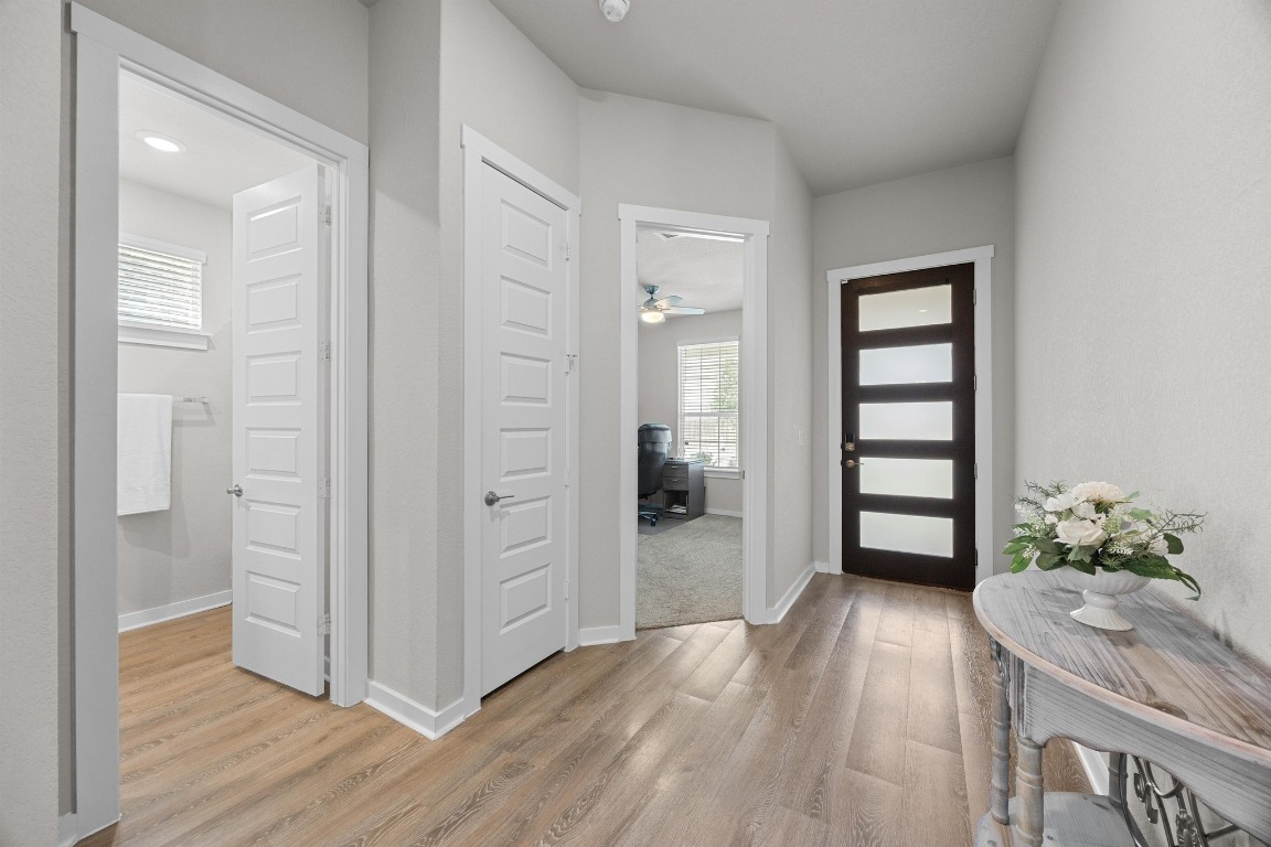 401 Peace Pipe Way Georgetown, TX 78628 - Photo 21 of 37 wooden floor and windows in a room