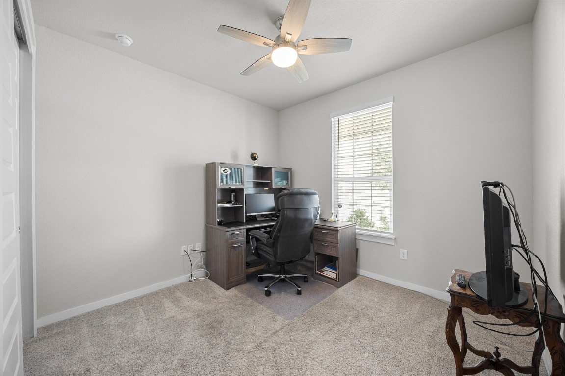 401 Peace Pipe Way Georgetown, TX 78628 - Photo 22 of 37 a view of a workspace with furniture and a window