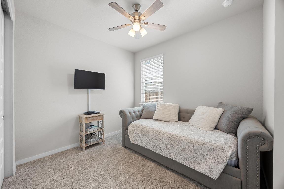 401 Peace Pipe Way Georgetown, TX 78628 - Photo 25 of 37 a bedroom with furniture and a large window
