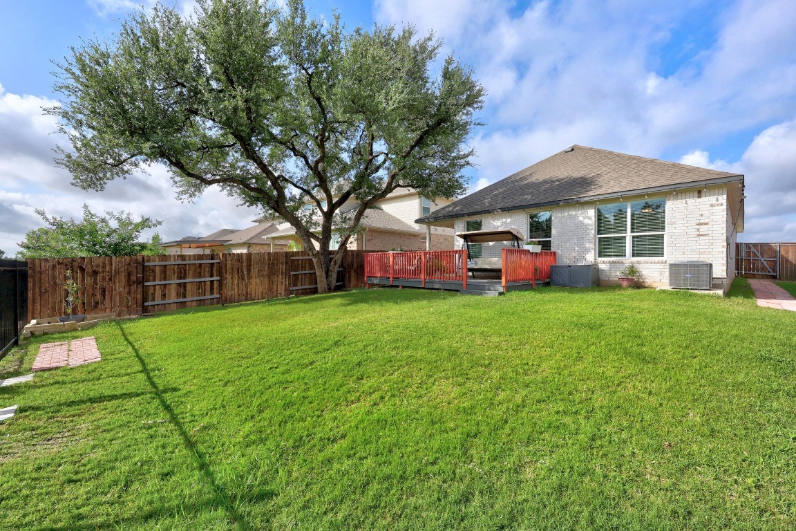 401 Peace Pipe Way Georgetown, TX 78628 - Photo 31 of 37 a view of a house with backyard and a tree