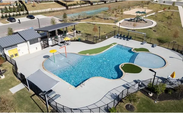 a view of a swimming pool with outdoor seating